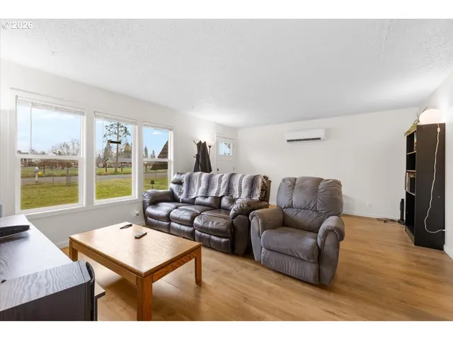 a living room with furniture a large window and a flat screen tv