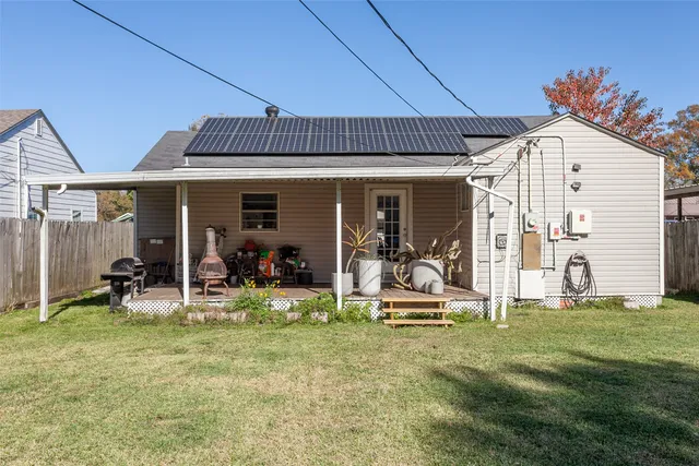 a view of a house with backyard and sitting area