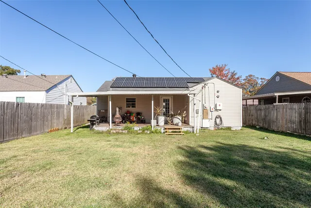 a view of a house with yard and sitting area