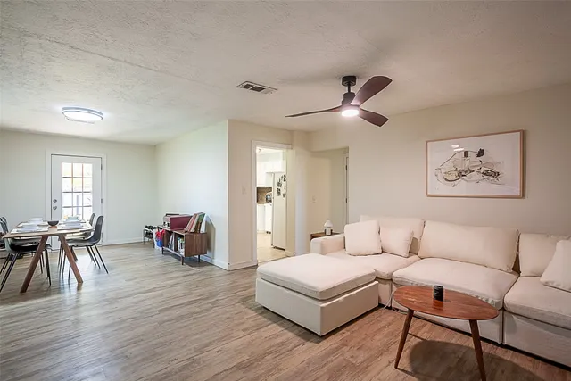 a living room with furniture and wooden floor