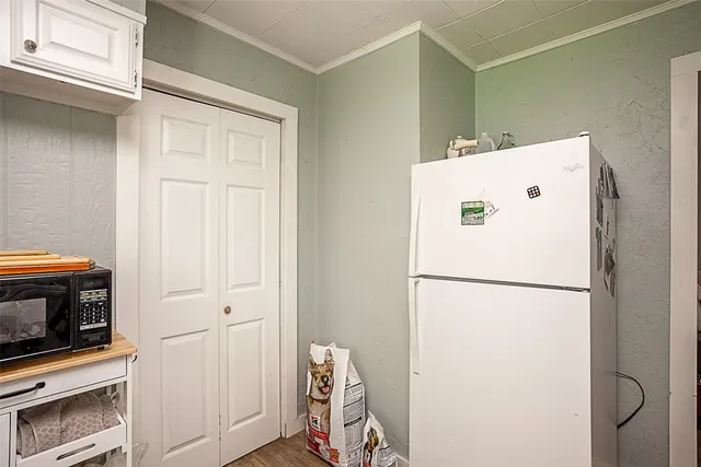 a white refrigerator freezer and a stove sitting inside of a kitchen