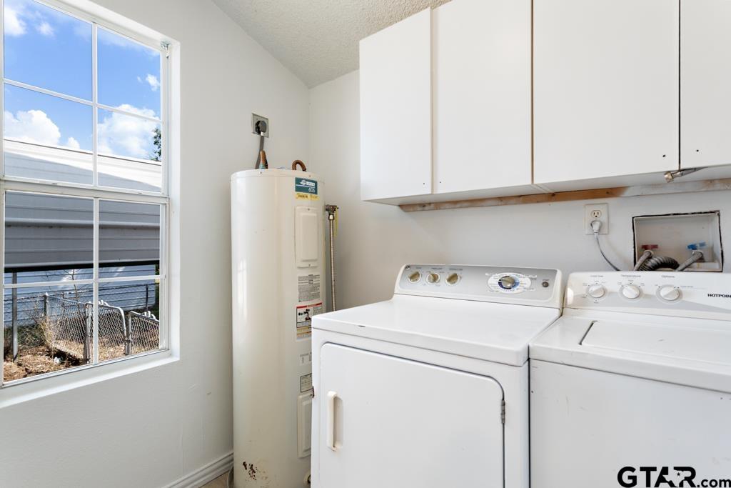 210 Cooper Street Lindale, TX 75771 - Photo 19 of 23 a view of storage and utility room with washer and dryer