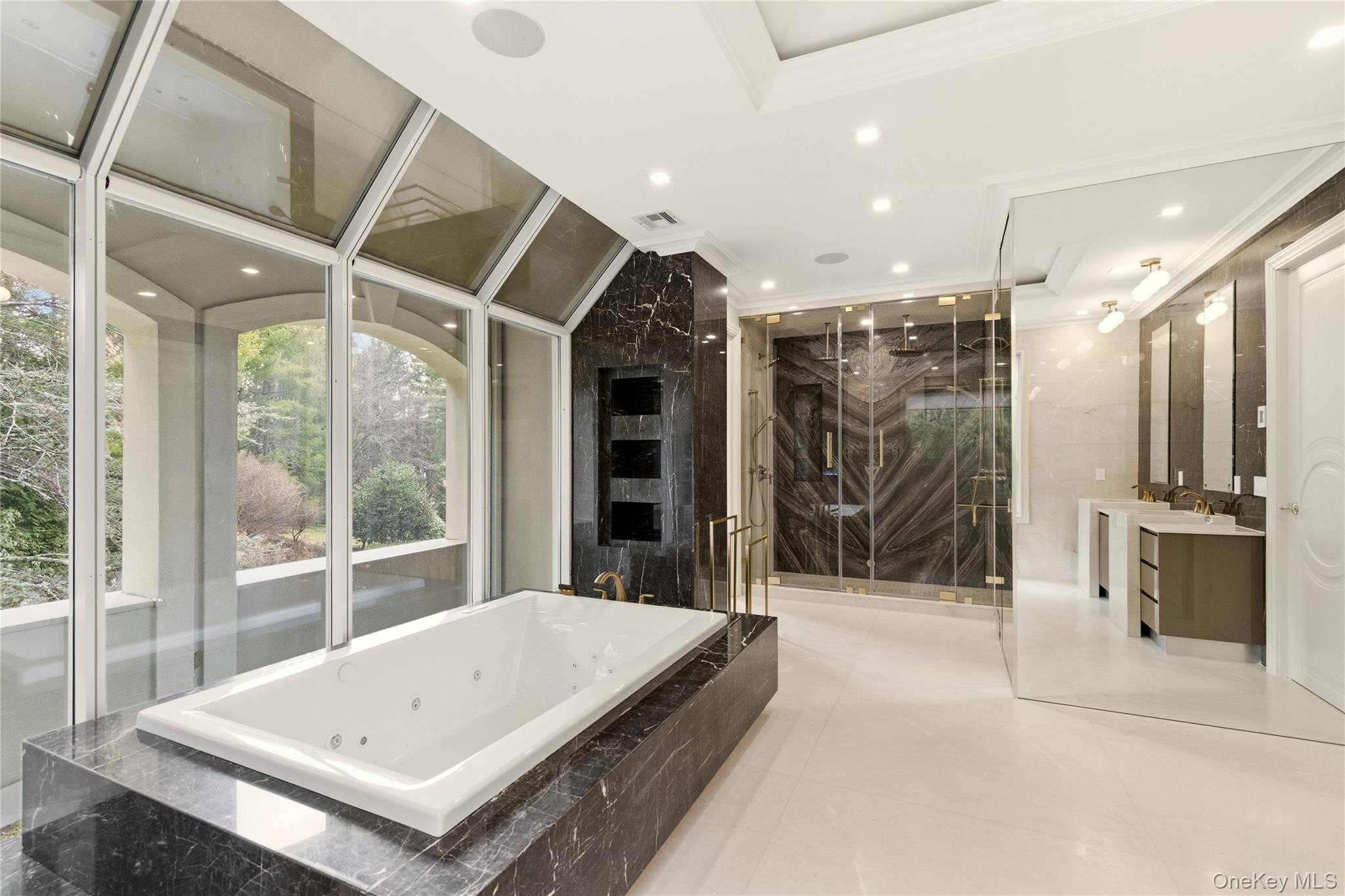 55 Coves Run Syosset, NY 11791 - Photo 28 of 50 a view of bathroom with a tub and glass door shower