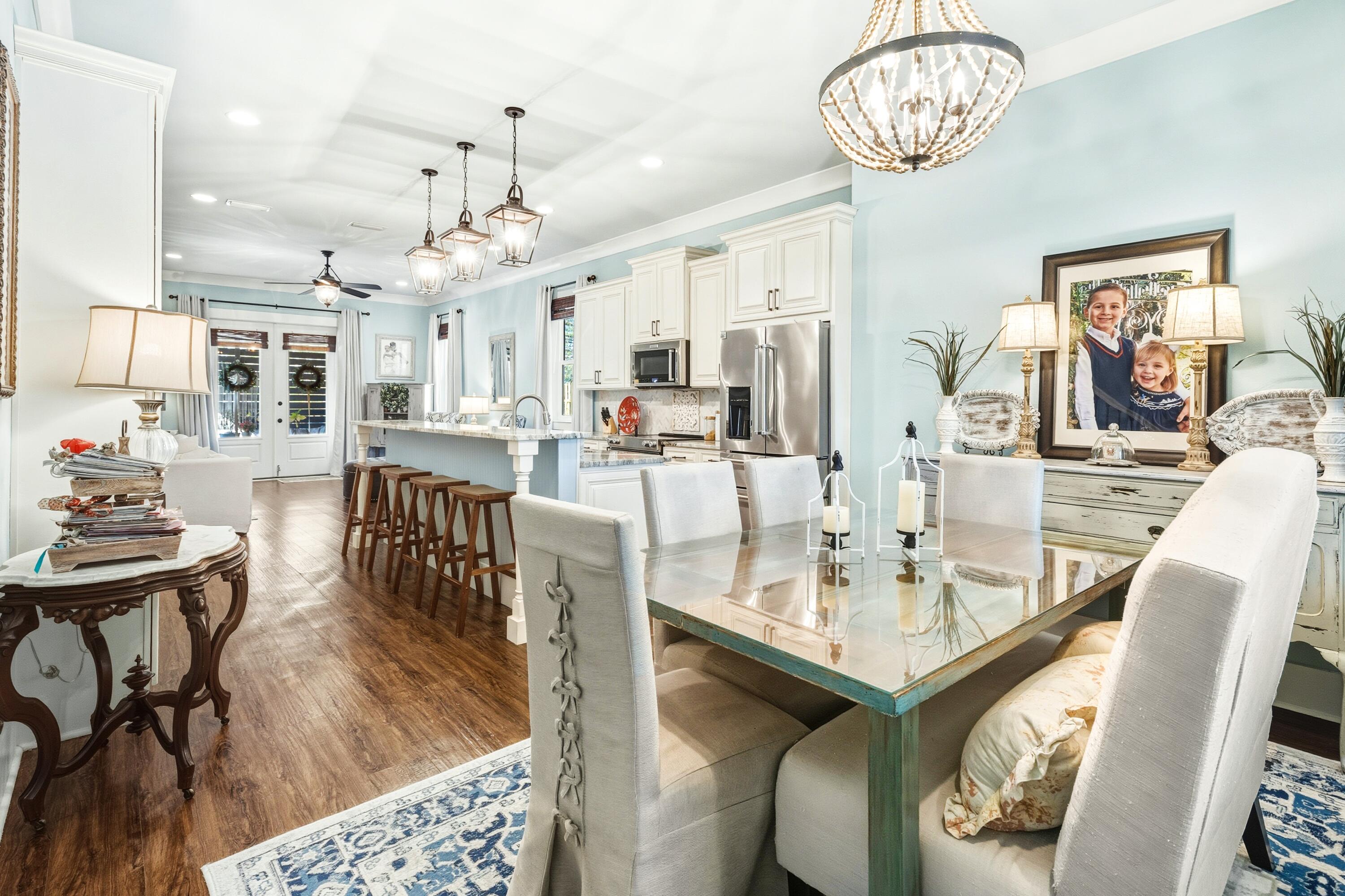 101 Botany Boulevard Santa Rosa Beach, FL 32459 - Photo 15 of 53 a view of a dining room with furniture wooden floor and chandelier