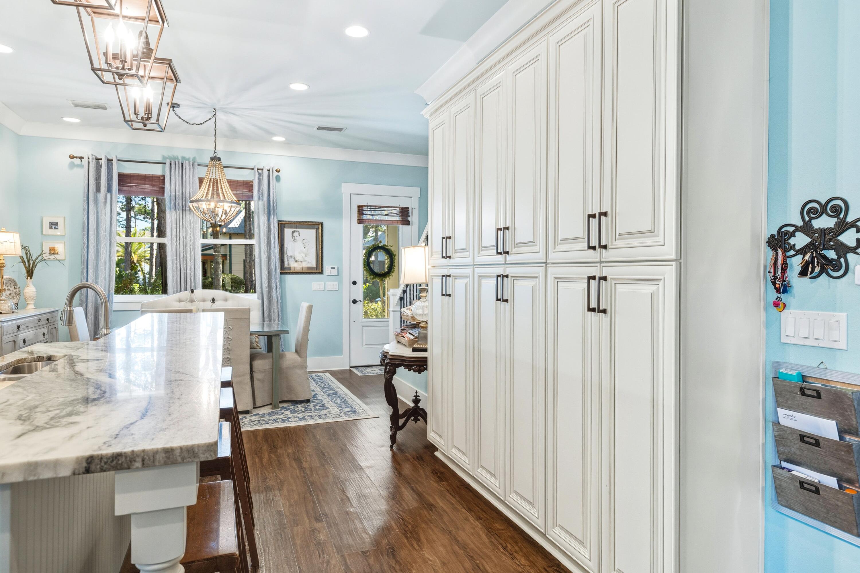 101 Botany Boulevard Santa Rosa Beach, FL 32459 - Photo 21 of 53 a view of a kitchen area with furniture and wooden floor