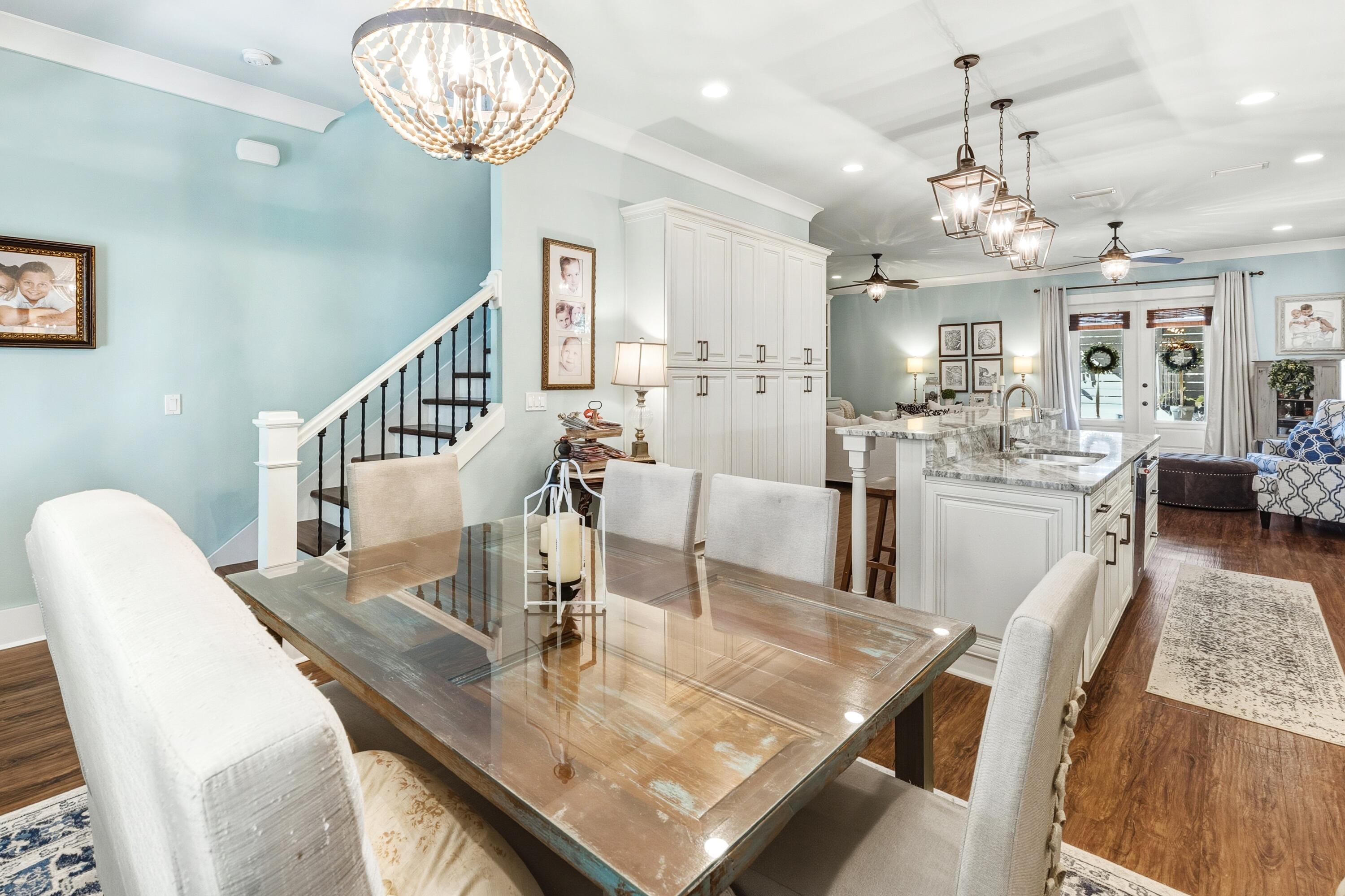 101 Botany Boulevard Santa Rosa Beach, FL 32459 - Photo 22 of 53 a view of a dining room with furniture a chandelier and wooden floor