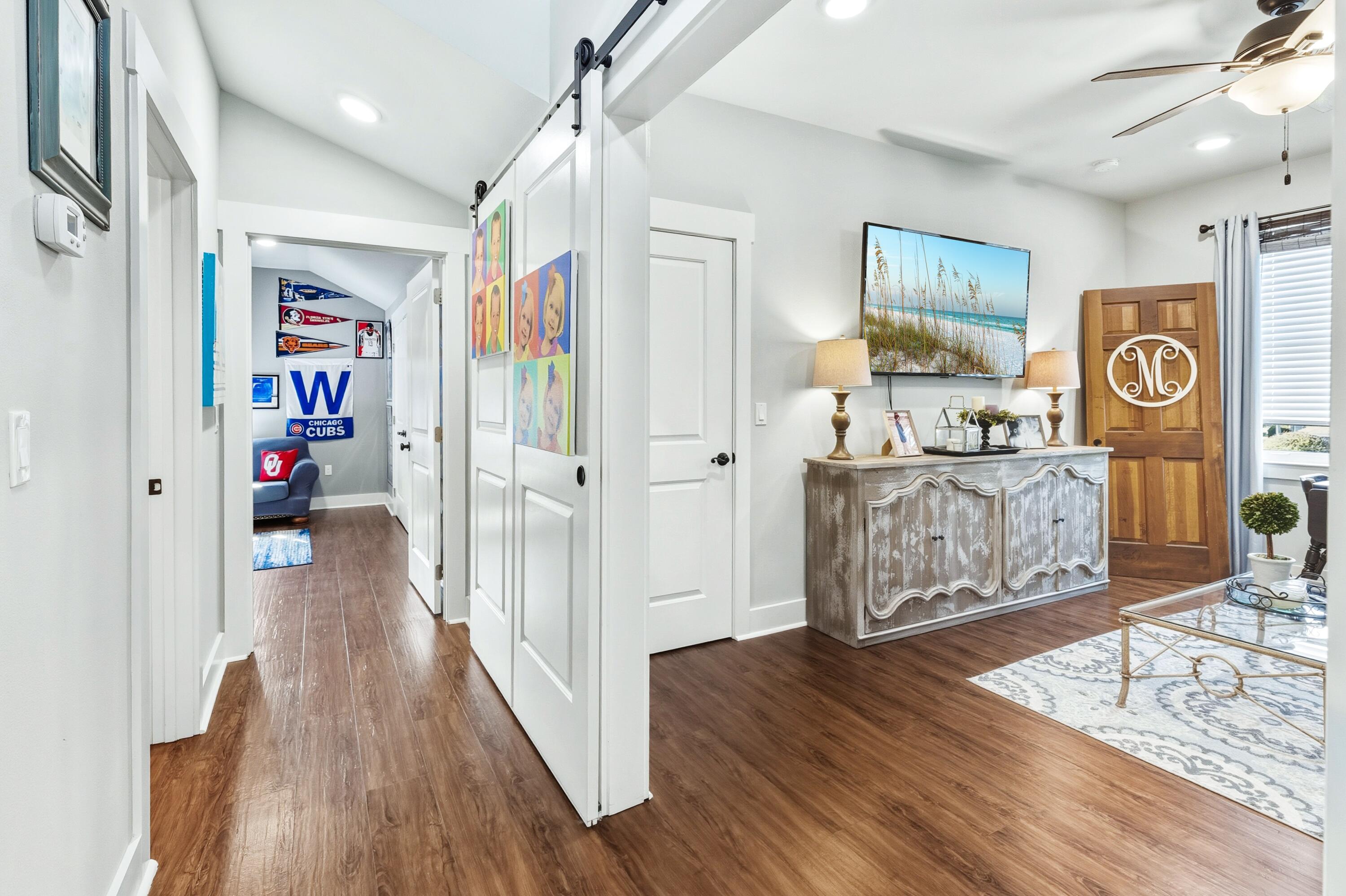 101 Botany Boulevard Santa Rosa Beach, FL 32459 - Photo 37 of 53 a view of a hallway with wooden floor and windows