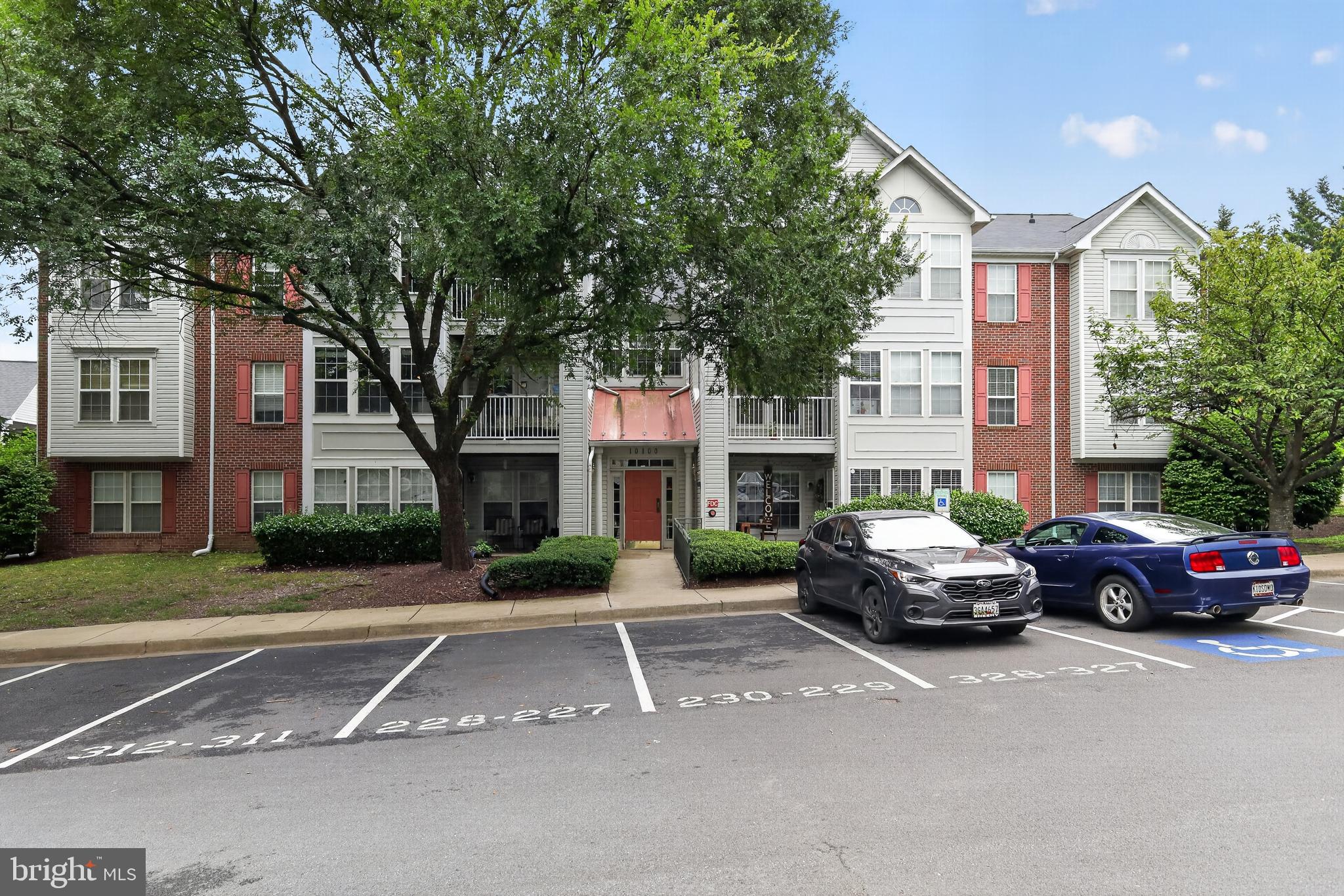 10100 Ridge Manor Terrace, Unit 5000L Damascus, MD 20872 - Photo 3 of 15 Condo entrance surrounded by lush greenery.