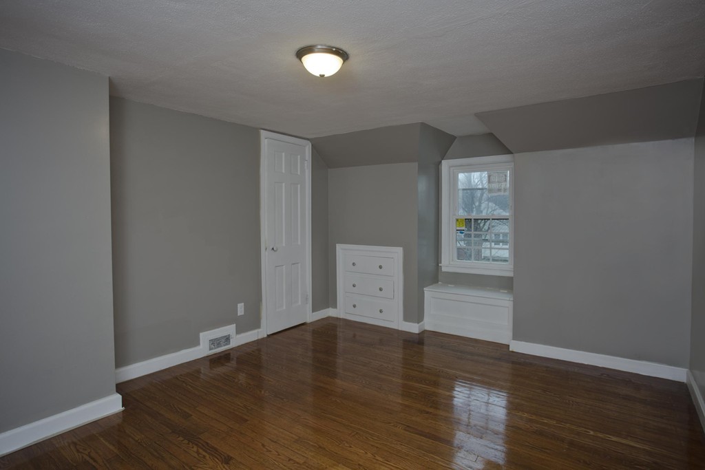 93 Haskin Street Springfield, MA 01109 - Photo 16 of 27 wooden floor in an empty room with a window