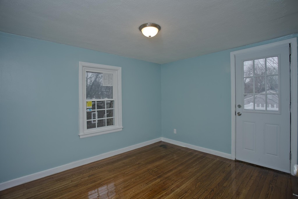 93 Haskin Street Springfield, MA 01109 - Photo 20 of 27 a view of an empty room with wooden floor and a window
