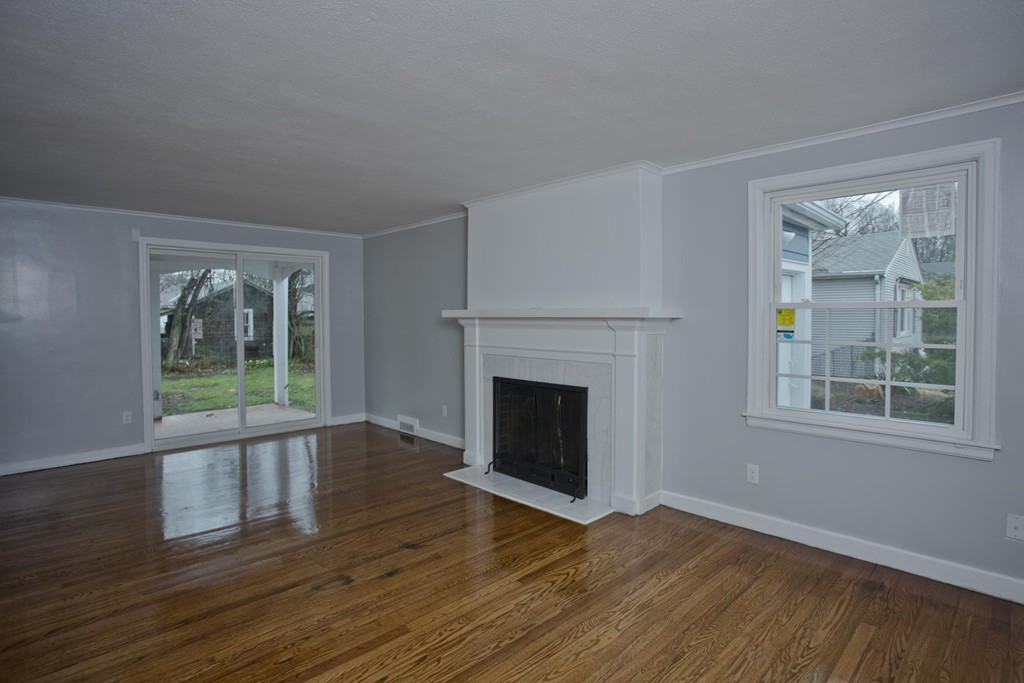 93 Haskin Street Springfield, MA 01109 - Photo 10 of 27 a view of empty room with wooden floor and fireplace