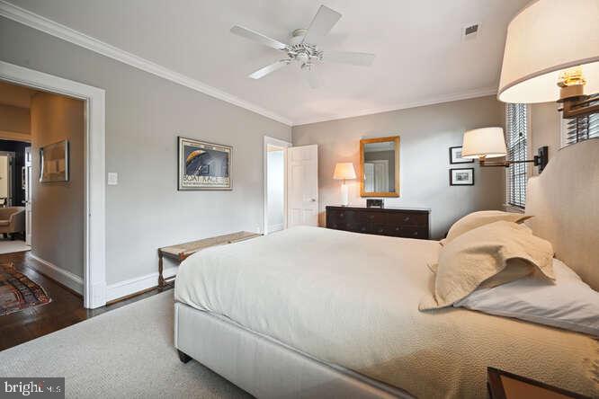 3629 Everett Street Northwest Washington, DC 20008 - Photo 21 of 51 a bedroom with a bed and dresser with mirror