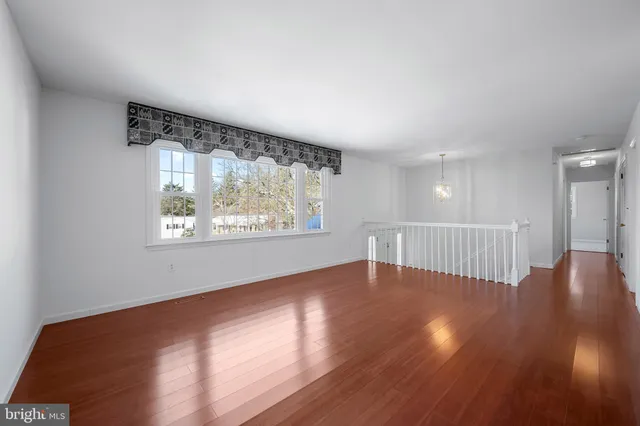 a view of a kitchen with microwave and wooden floor