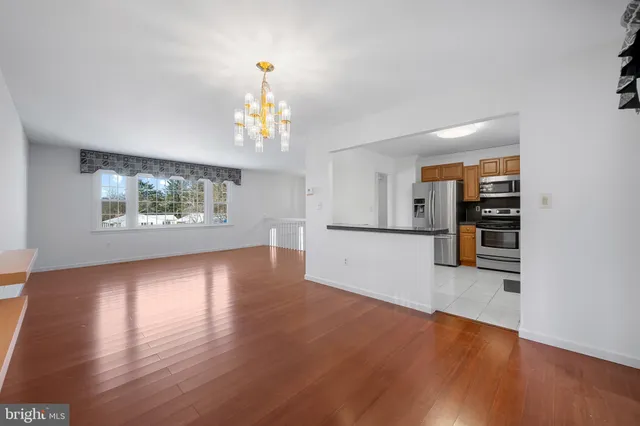 a kitchen with granite countertop stainless steel appliances a refrigerator sink and microwave