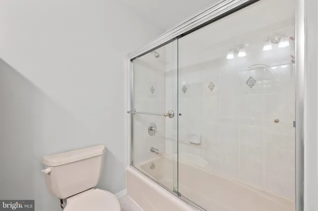 an empty room with a white walls and windows