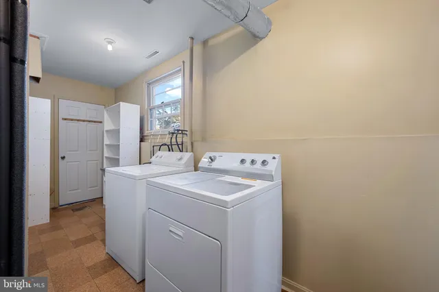 a view of a house with a backyard and a patio