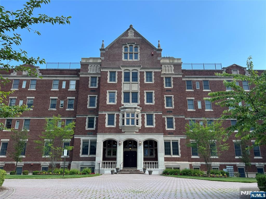 a front view of a residential apartment building with a yard