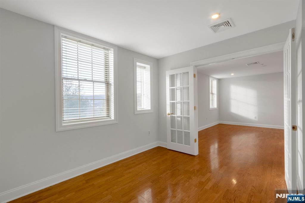 5401 Rio Vista Drive Mahwah, NJ 07430 - Photo 19 of 26 a view of an empty room with wooden floor and a window