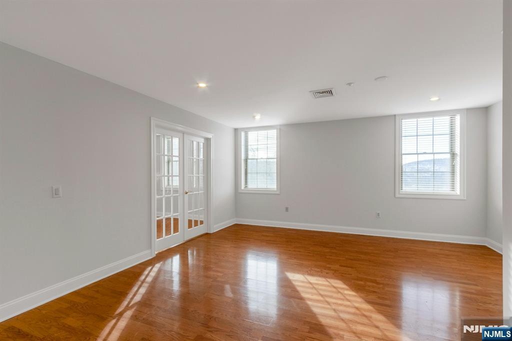 5401 Rio Vista Drive Mahwah, NJ 07430 - Photo 21 of 26 a view of empty room with wooden floor and fan
