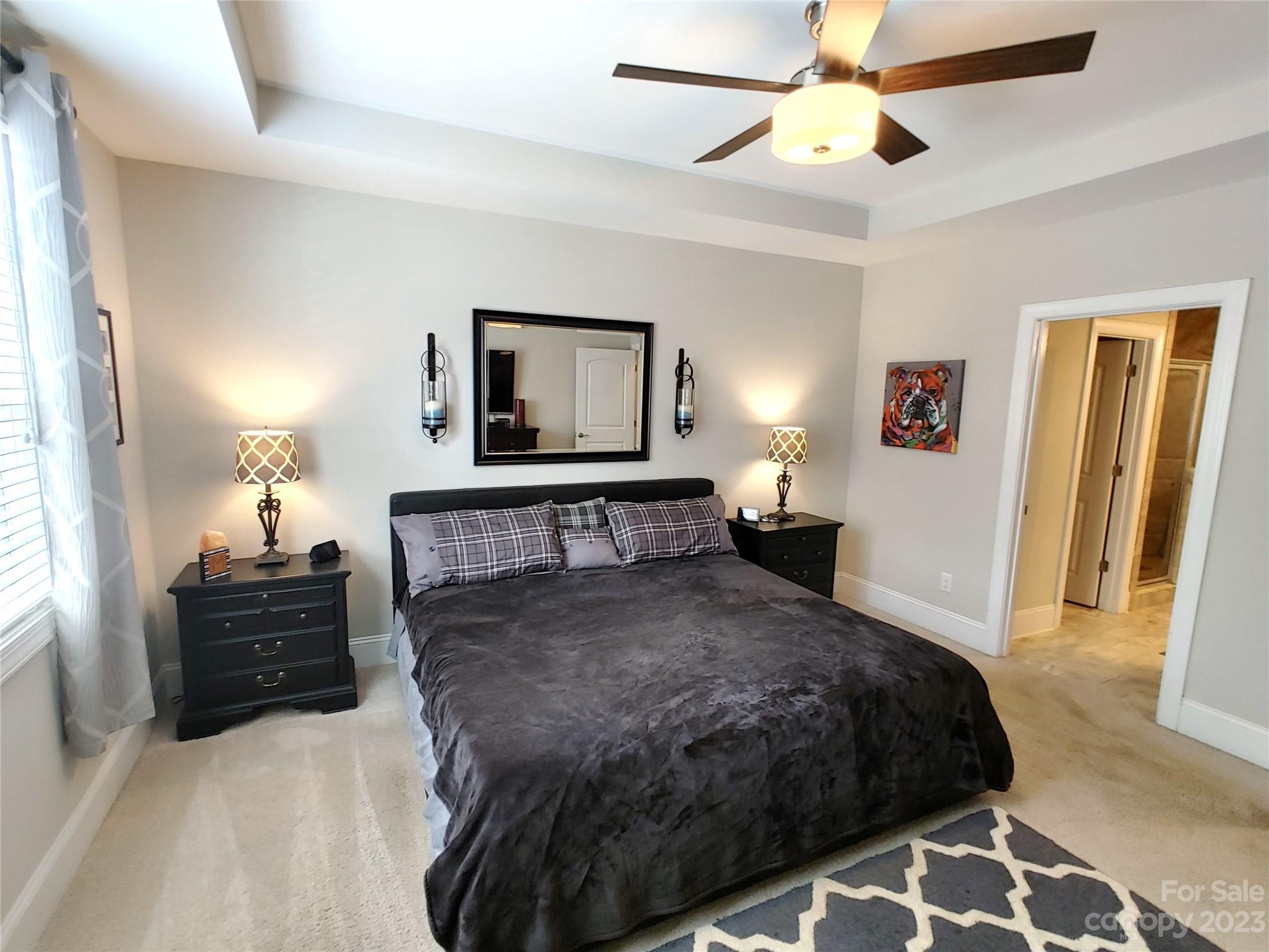 902 Ospre Lane Fort Mill, SC 29708 - Photo 19 of 44 a bedroom with a bed and a chandelier