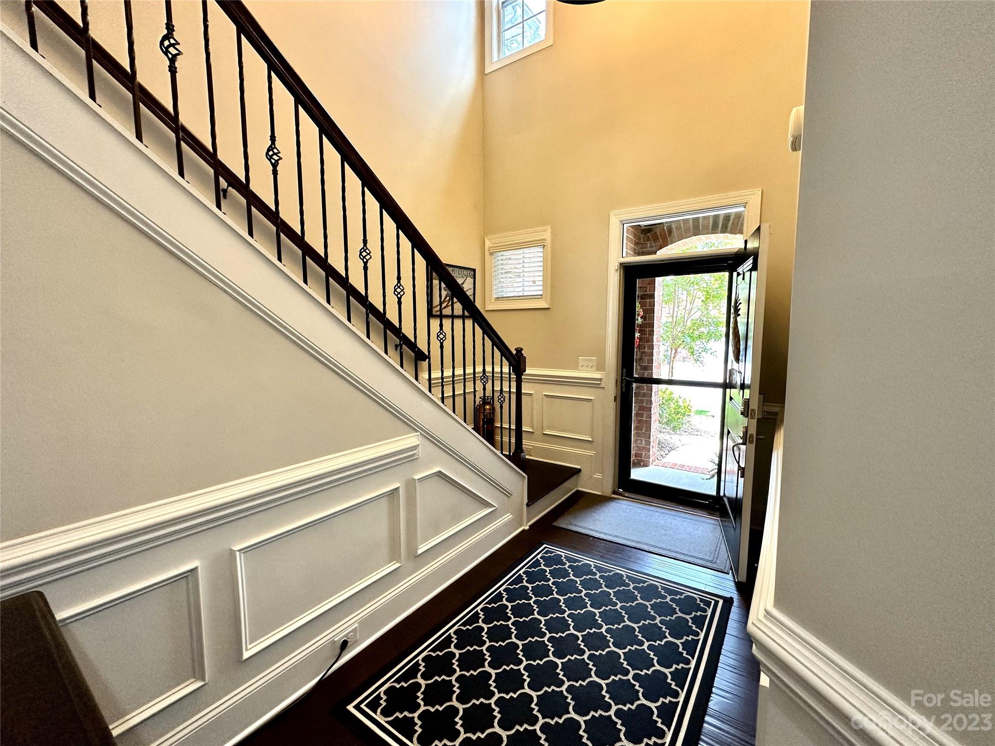 902 Ospre Lane Fort Mill, SC 29708 - Photo 4 of 44 a view of a hallway with wooden floor and stairs