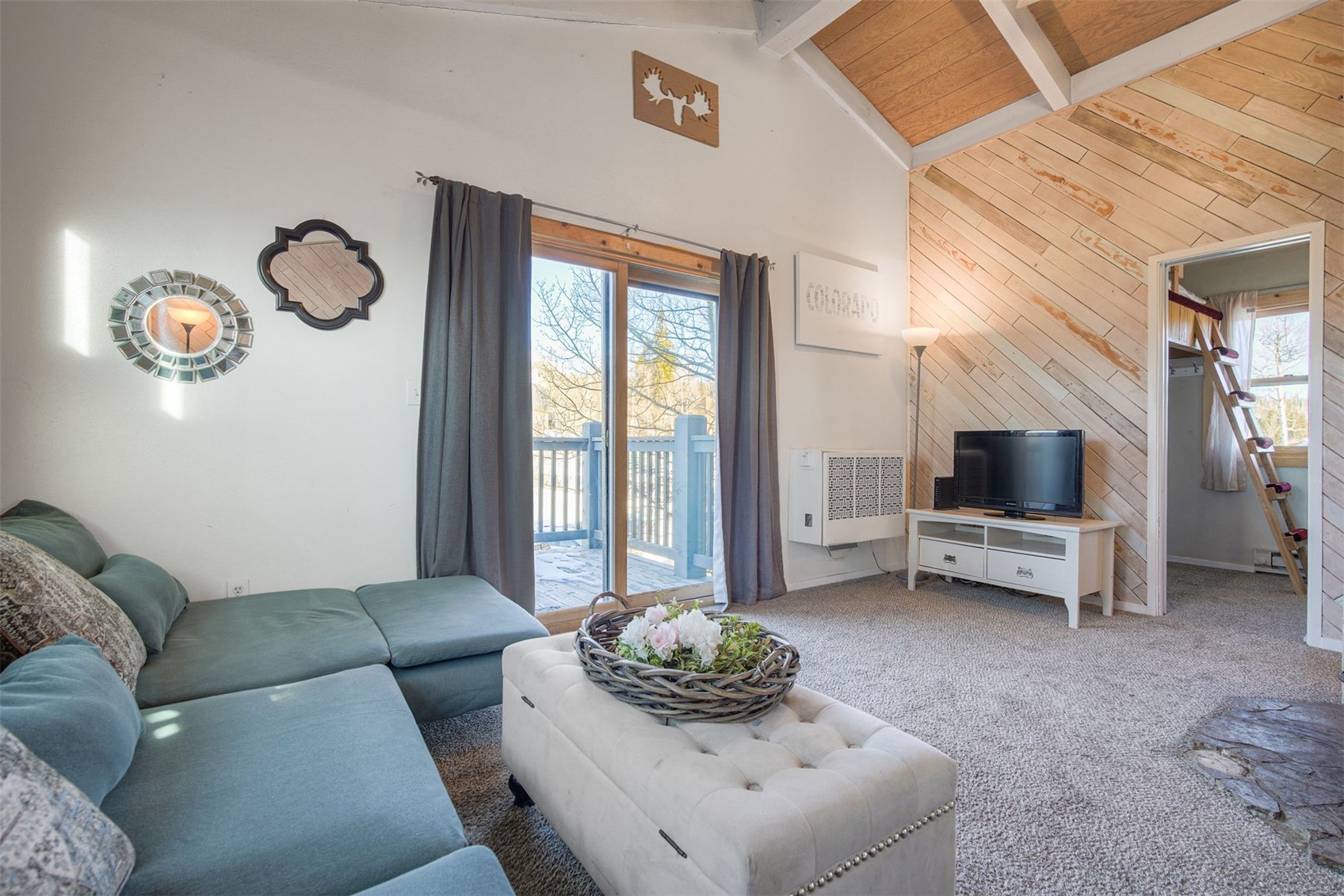 8018 Ryan Gulch Road, Unit B9 Silverthorne, CO 80498 - Photo 4 of 17 a living room with furniture and a flat screen tv