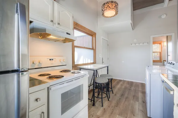 a kitchen that has a sink a stove and window