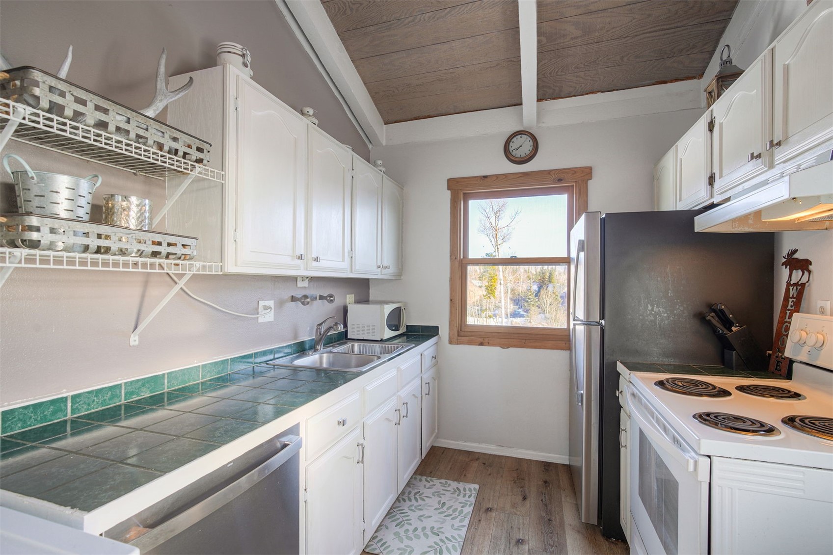 8018 Ryan Gulch Road, Unit B9 Silverthorne, CO 80498 - Photo 8 of 17 a kitchen that has a sink a stove and window
