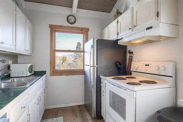 a view of an entryway with wooden floor
