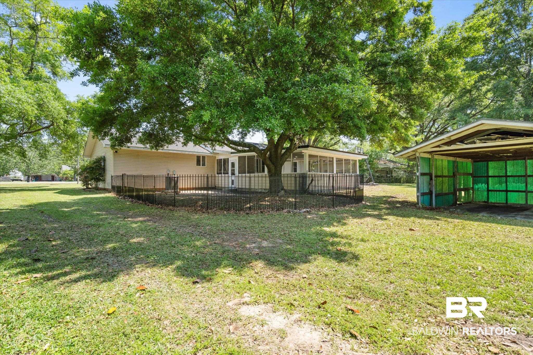 529 Cleveland Road Saraland, AL 36571 - Photo 25 of 31 View of yard featuring a sunroom and fence