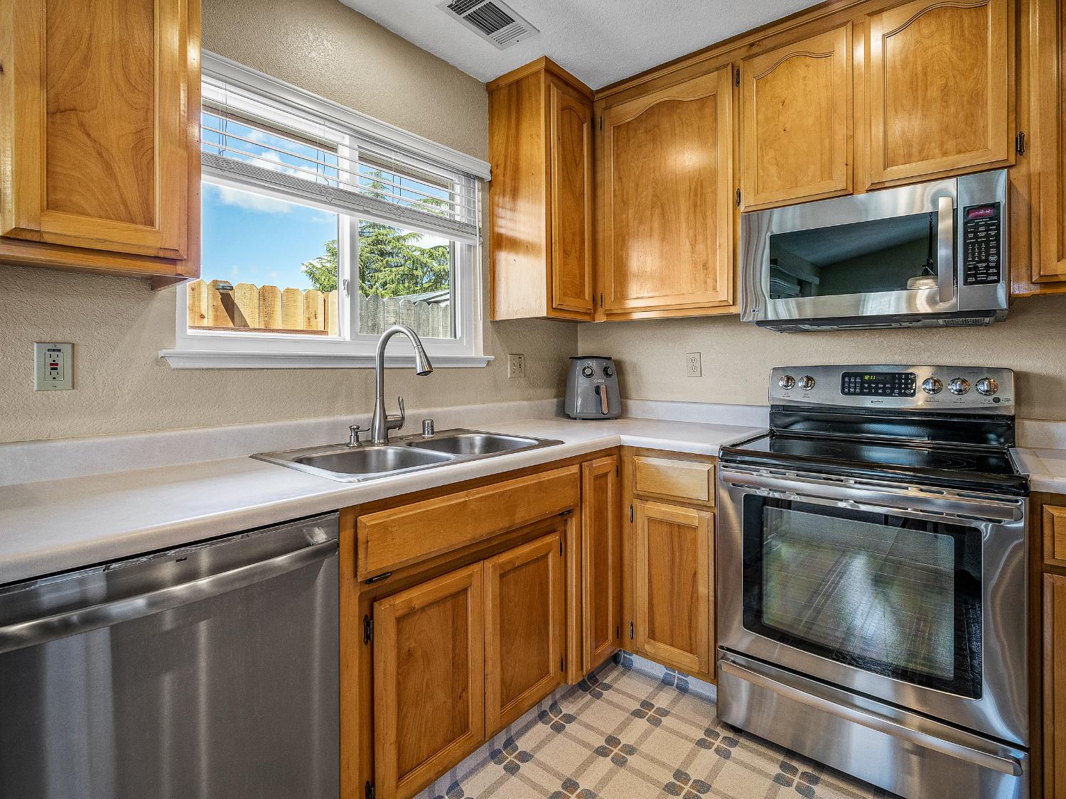 4914 Summit View Court El Dorado, CA 95623 - Photo 11 of 31 a kitchen with stainless steel appliances a stove sink and microwave