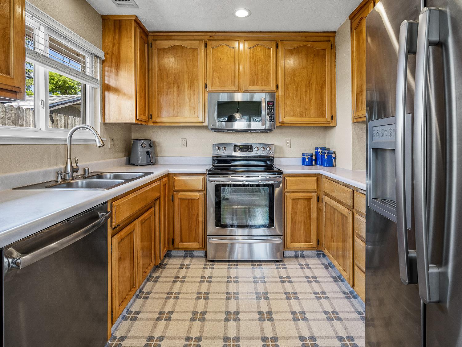 4914 Summit View Court El Dorado, CA 95623 - Photo 12 of 31 a kitchen with stainless steel appliances granite countertop a stove a sink and a microwave