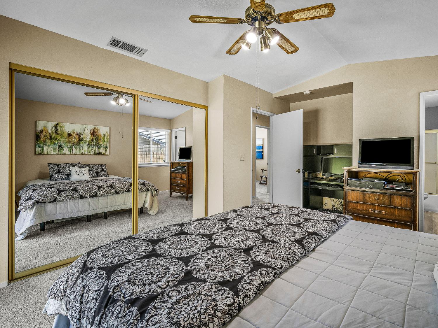 4914 Summit View Court El Dorado, CA 95623 - Photo 14 of 31 a bedroom with a large bed and a flat screen tv