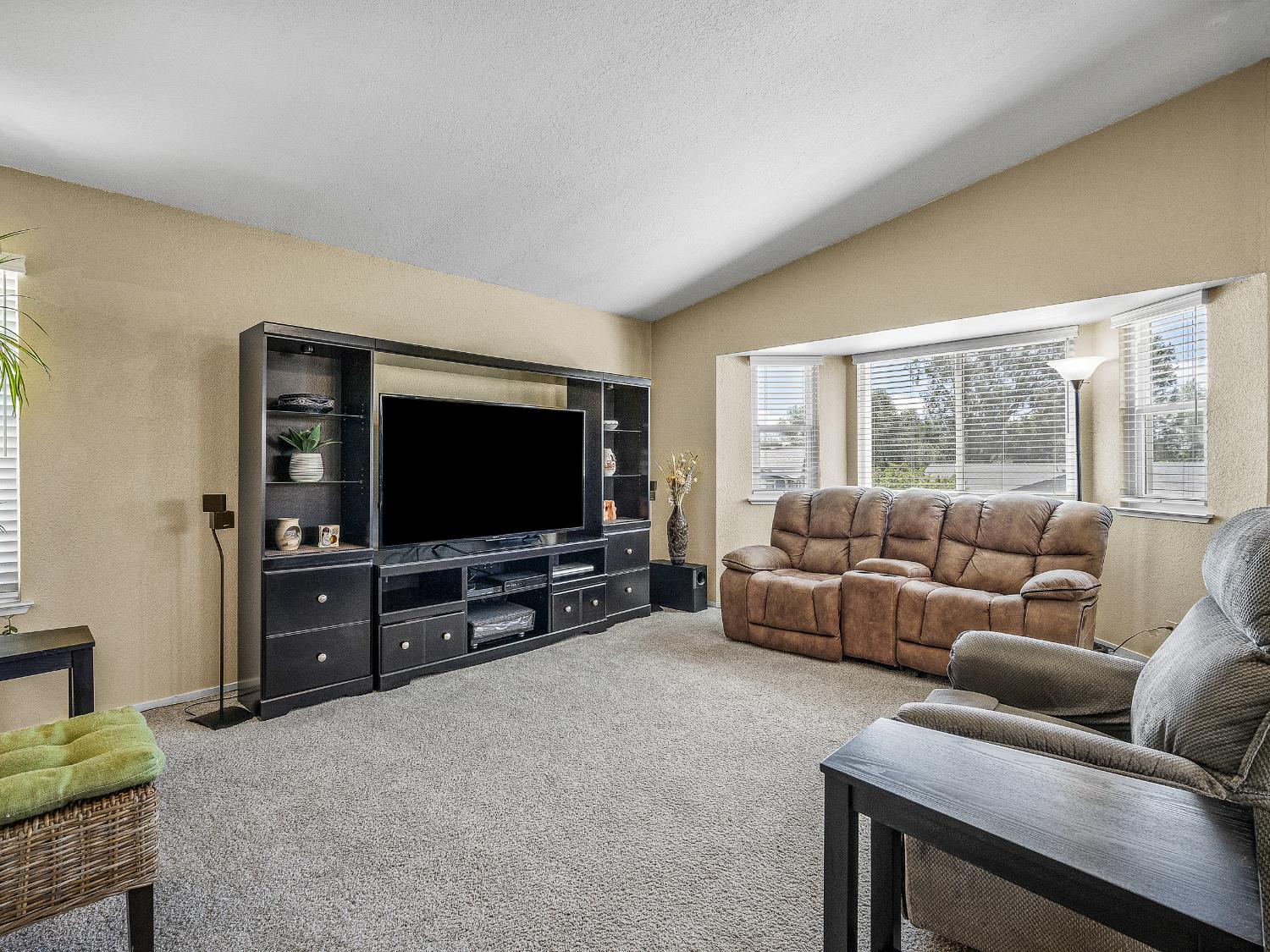 4914 Summit View Court El Dorado, CA 95623 - Photo 7 of 31 a living room with furniture and a flat screen tv