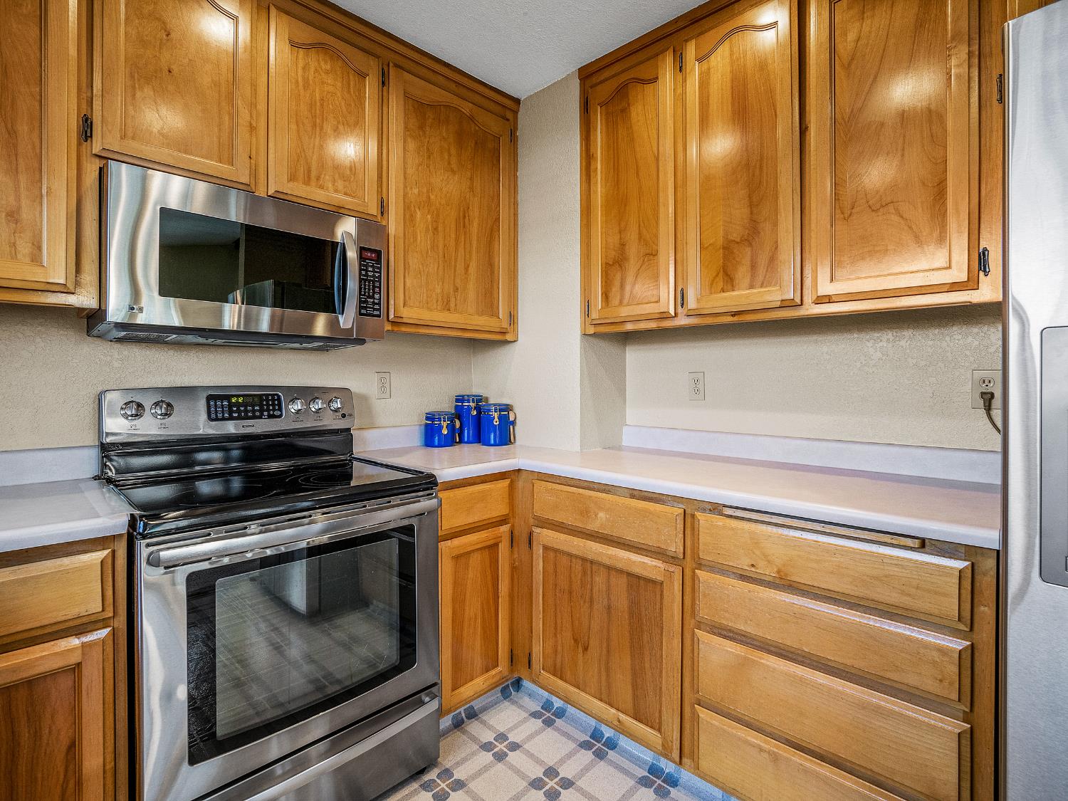 4914 Summit View Court El Dorado, CA 95623 - Photo 10 of 31 a kitchen with stainless steel appliances granite countertop a stove and a microwave