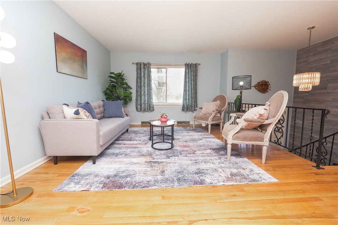 2674 Smith Road Fairlawn, OH 44333 - Photo 8 of 31 Living area with a chandelier, baseboards, and wood finished floors
