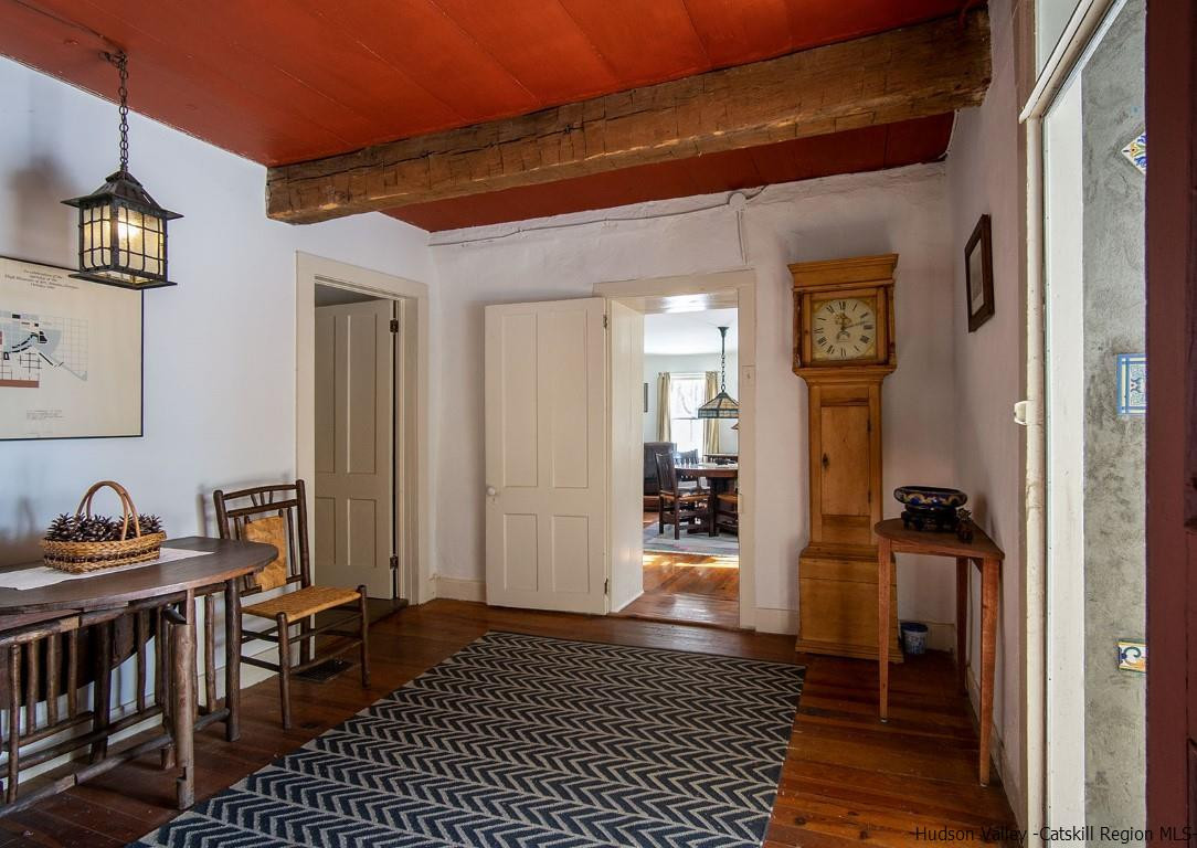 174 Peak Road Stone Ridge, NY 12484 - Photo 11 of 29 a view of a hallway with wooden floor and a livingroom