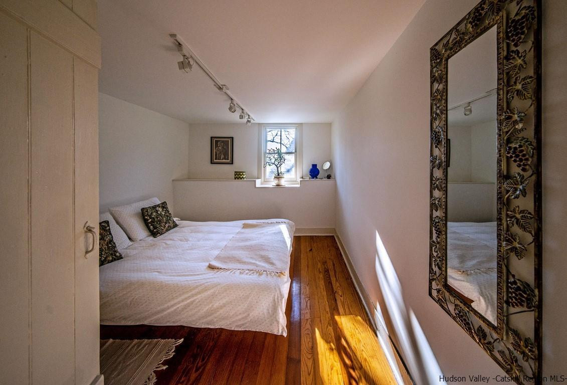 174 Peak Road Stone Ridge, NY 12484 - Photo 14 of 29 a bedroom with a bed and wooden floor