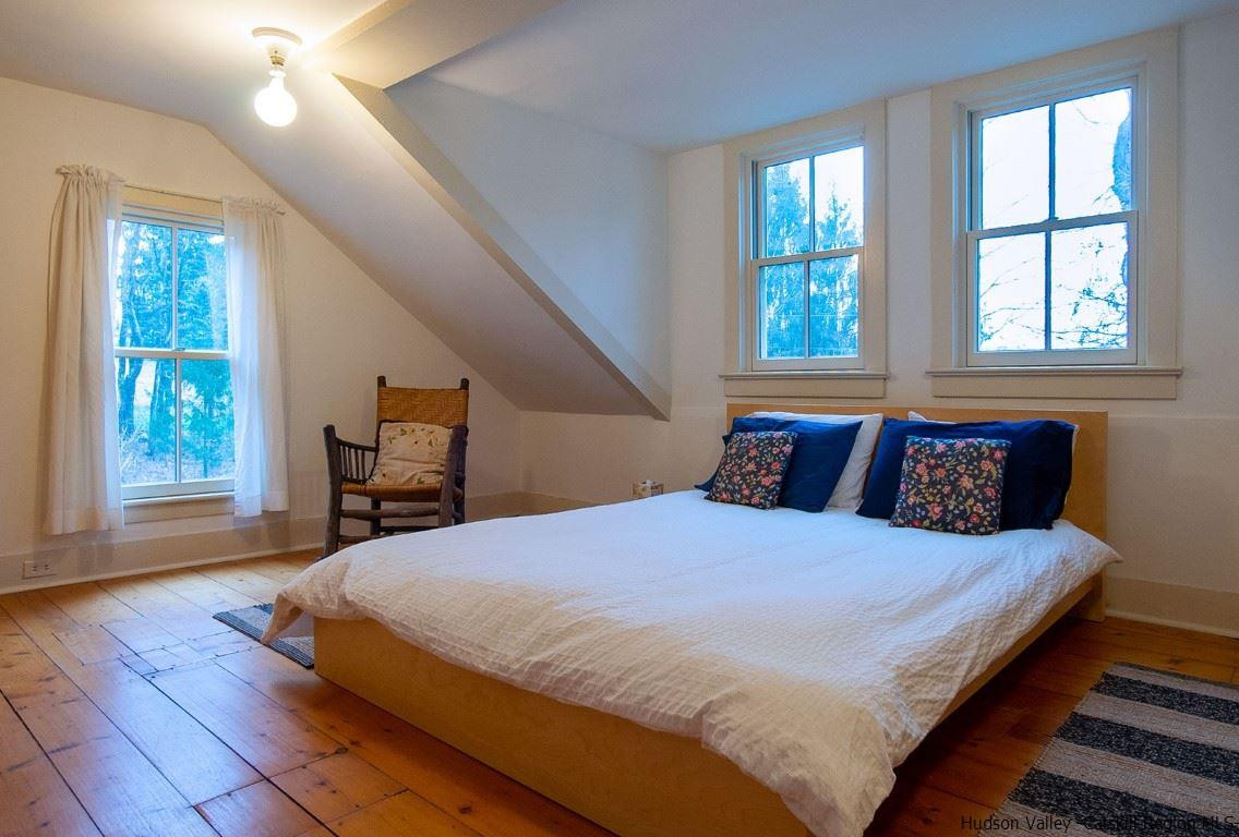 174 Peak Road Stone Ridge, NY 12484 - Photo 16 of 29 a bedroom with a bed and wooden floor