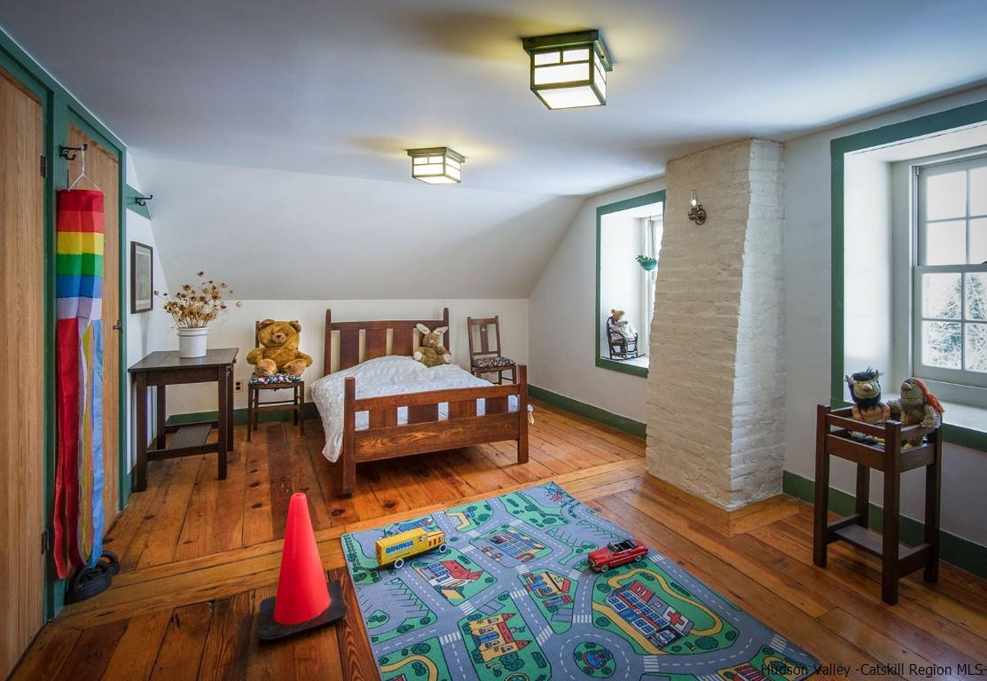 174 Peak Road Stone Ridge, NY 12484 - Photo 17 of 29 a bedroom with furniture and a wooden floor