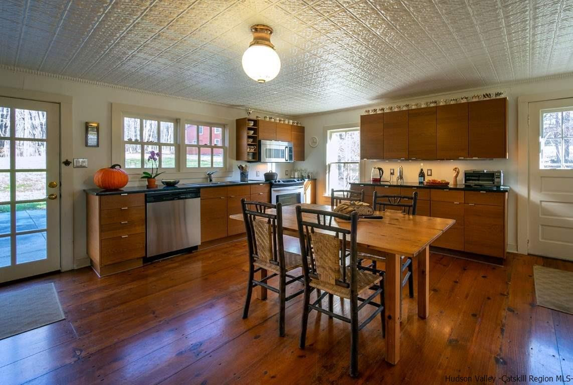 174 Peak Road Stone Ridge, NY 12484 - Photo 7 of 29 a view of a dining room with furniture and wooden floor