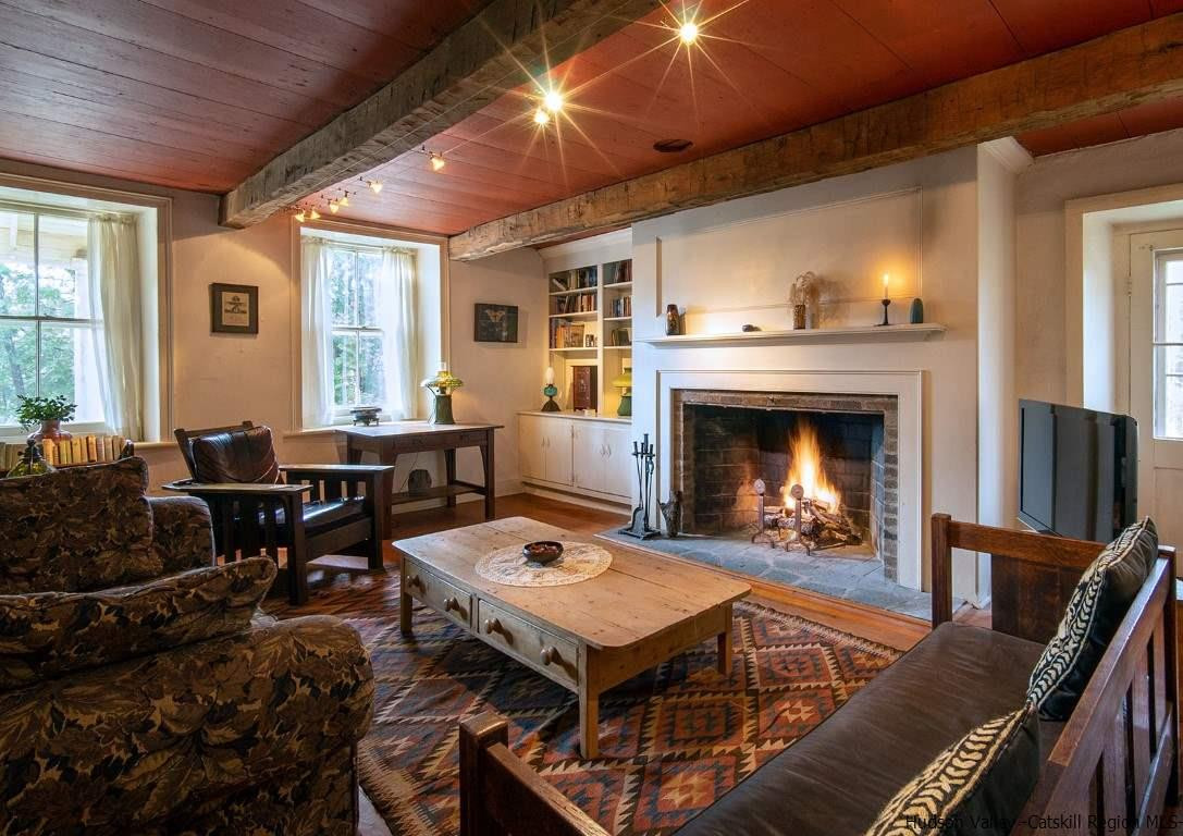 174 Peak Road Stone Ridge, NY 12484 - Photo 10 of 29 a living room with furniture a fireplace and a table