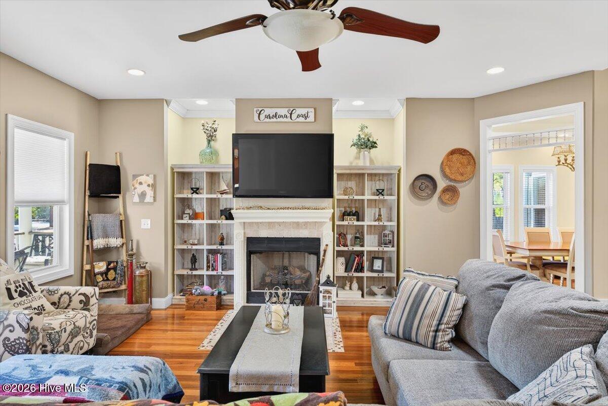 18 Brierwood Road Southwest Shallotte, NC 28470 - Photo 11 of 70 Comfortable main living area featuring hardwood floors, ceiling fan, and open flow into dining and kitchen spaces.