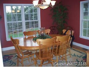 780 Meadow Crest Road Tryon, NC 28782 - Photo 8 of 12 a view of a dining room with furniture wooden floor and a chandelier