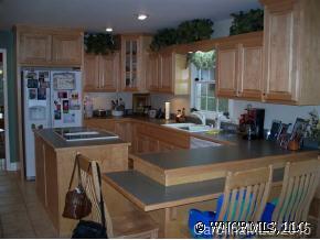 780 Meadow Crest Road Tryon, NC 28782 - Photo 9 of 12 a kitchen with stainless steel appliances granite countertop a sink a stove and a refrigerator