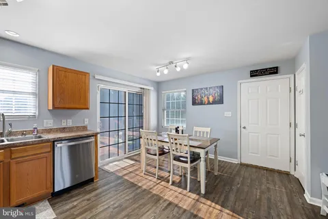 a view of a kitchen with a dining table chairs and wooden floor