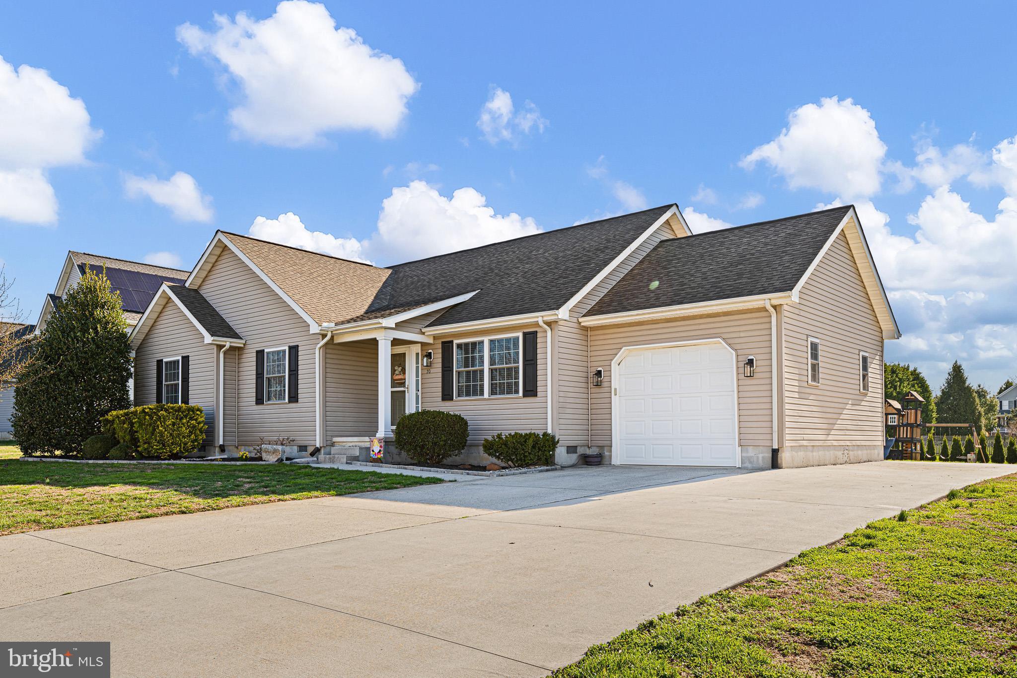 70 West Deer Trail Road Clayton, DE 19938 - Photo 3 of 25 a front view of a house with a garden