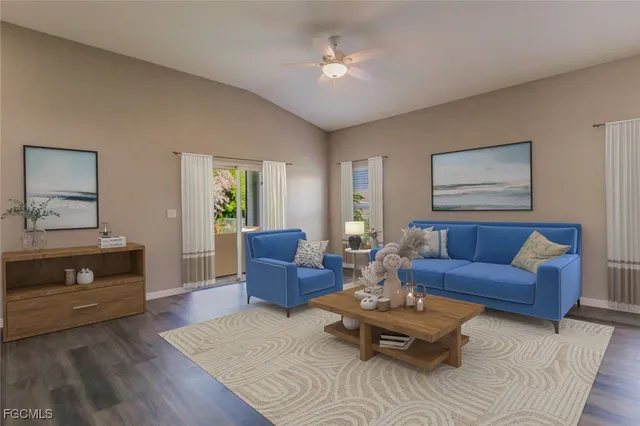 a living room with furniture ceiling fan and a window