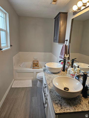 7481 Red Pine Road Eagle Mountain, UT 84005 - Photo 23 of 38 Master bathroom featuring a double vanity with granite countertop, vessel sinks, and dark bronze fixtures