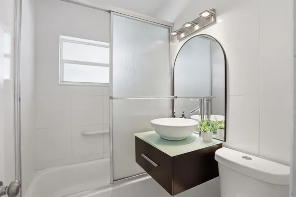 a bathroom with a sink toilet and shower